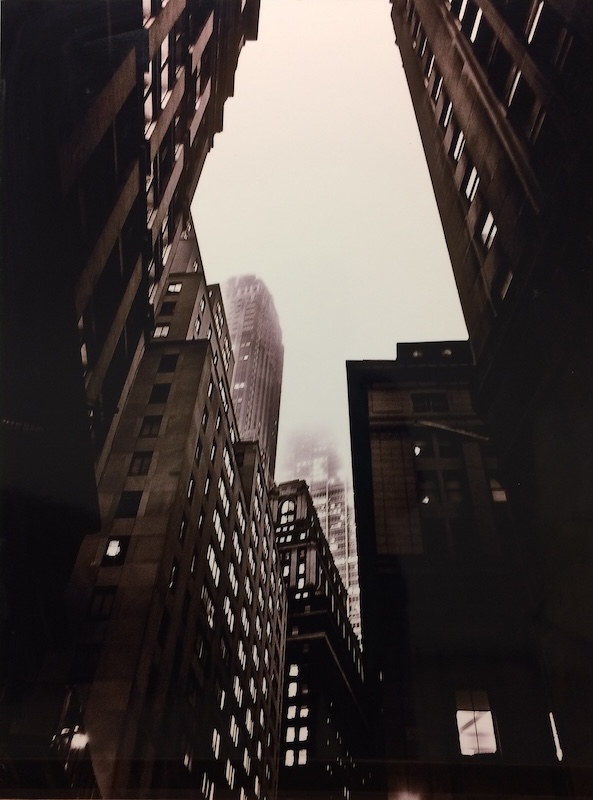 Charles Jerry Ayers' photograph on Plexiglas "New York City Buildings" is a black-and-white shot looking up at towering buildings