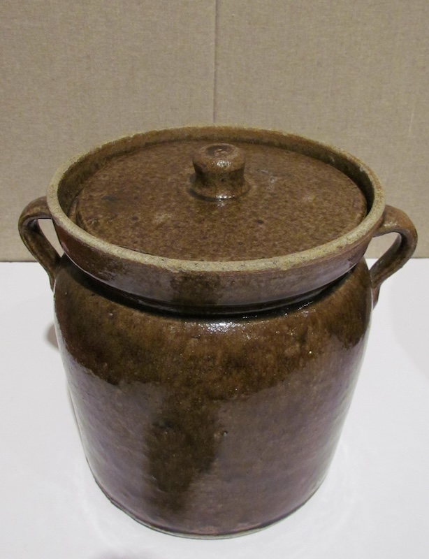 A brown stoneware "Bean pot with lid and loop handles" by the Foreman Pottery Company