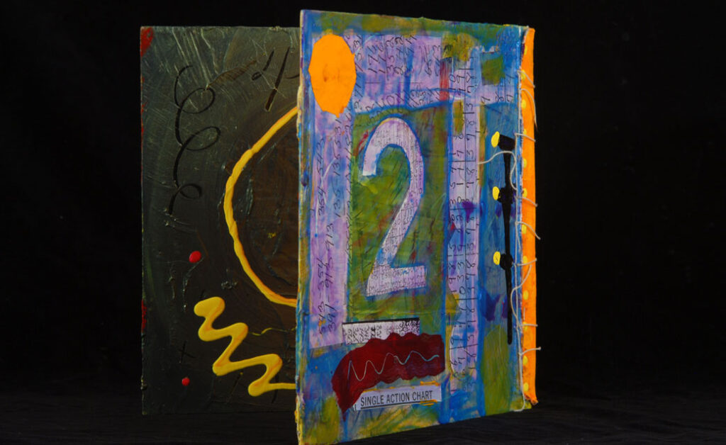 A detail of a collaged artist's book by Joyce Wellman, featuring the number 2 in purple on the back