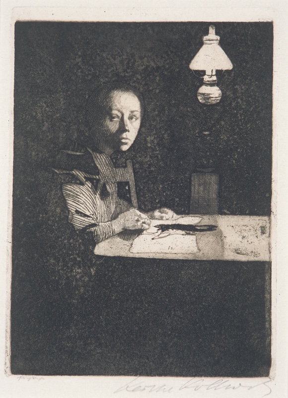 Black-and-white portrait of a woman setting at a table 