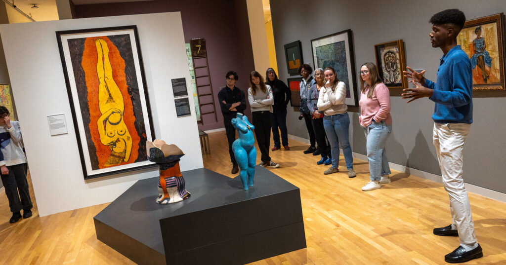 Exhibition design intern Winston Lovelace leading a gallery tour