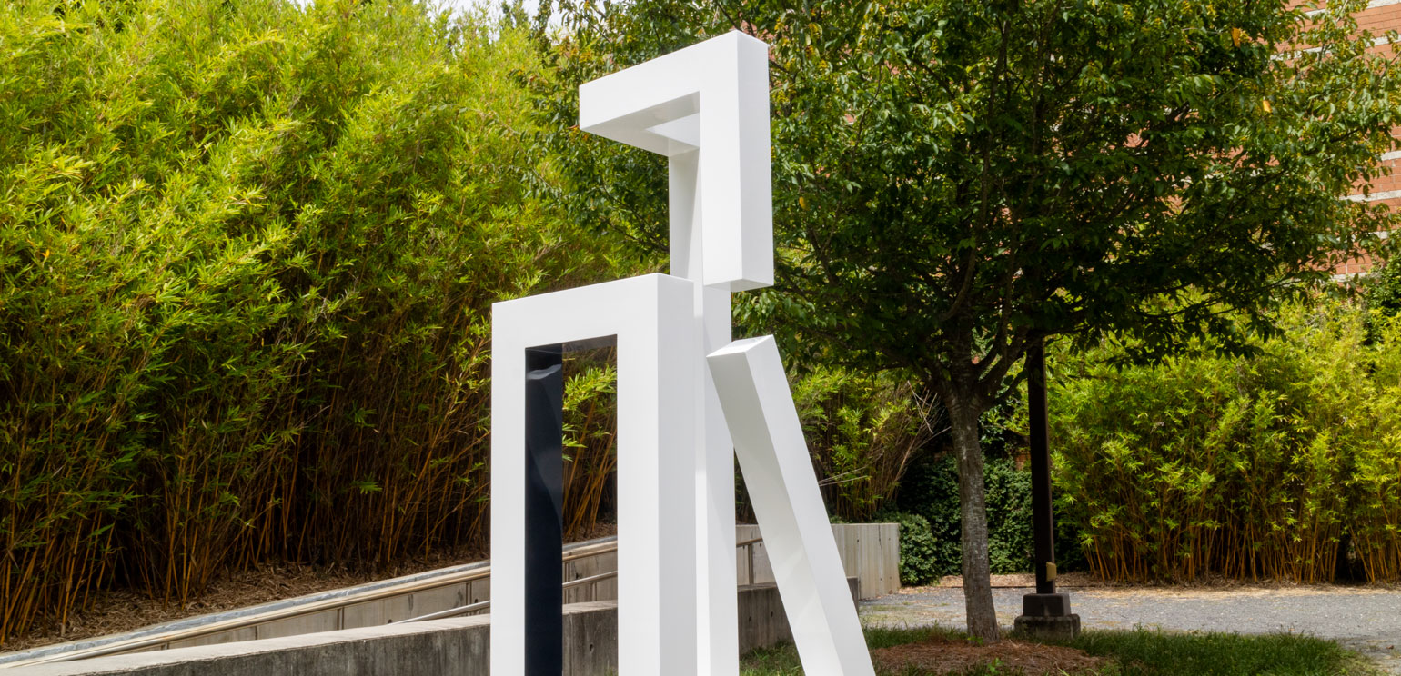 Jane Manus' geometric aluminum sculpture, painted white, titled "Not Yet," installed in the museum's sculpture garden