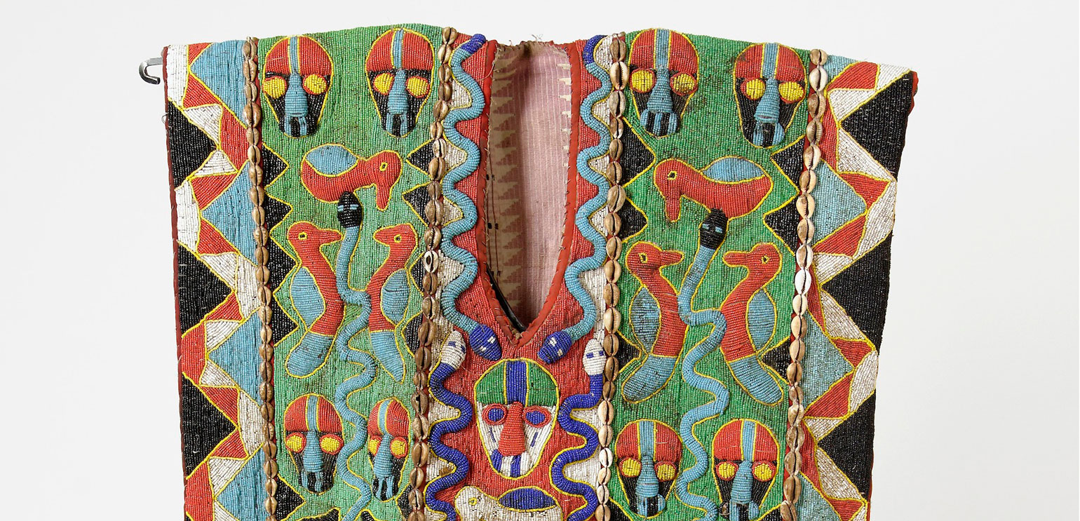 Detail of a brightly colored embroidered Yoruba vest, with images in red, green, blue, and yellow