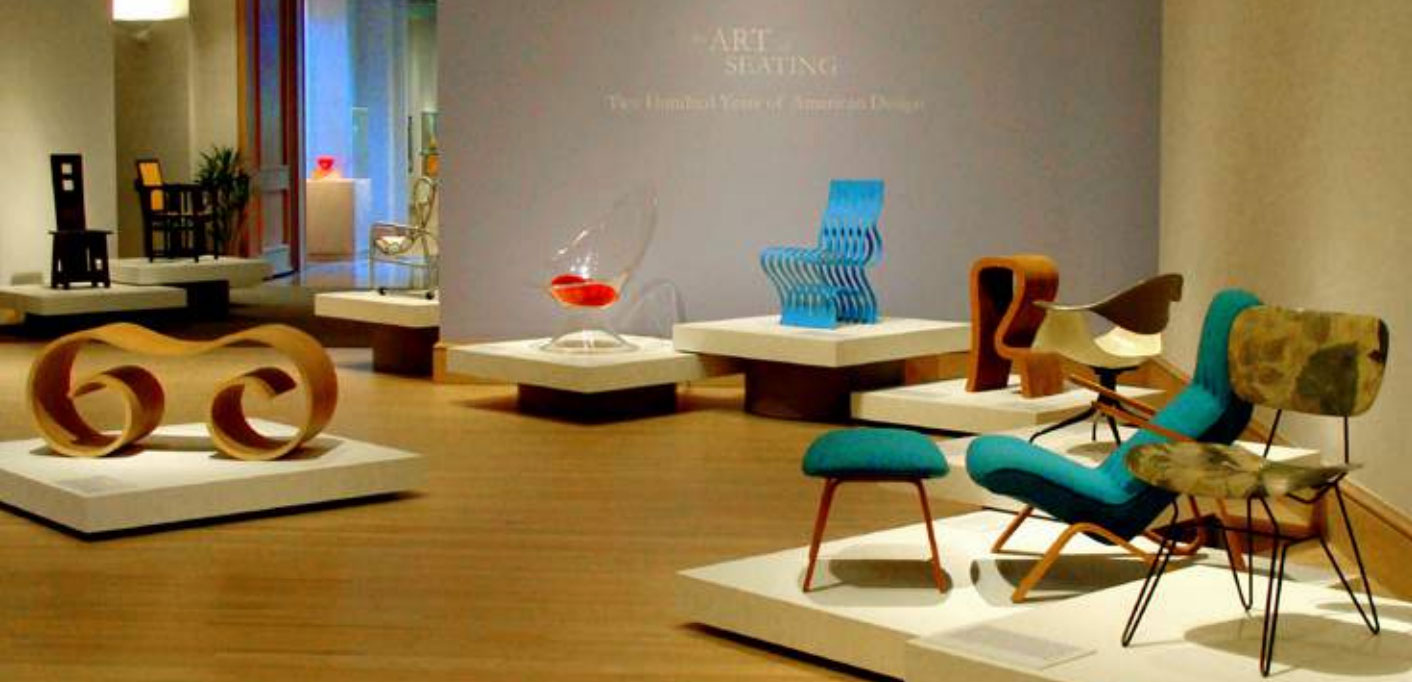 An installation view of the exhibition, with a lot of different kinds of seating, at another museum