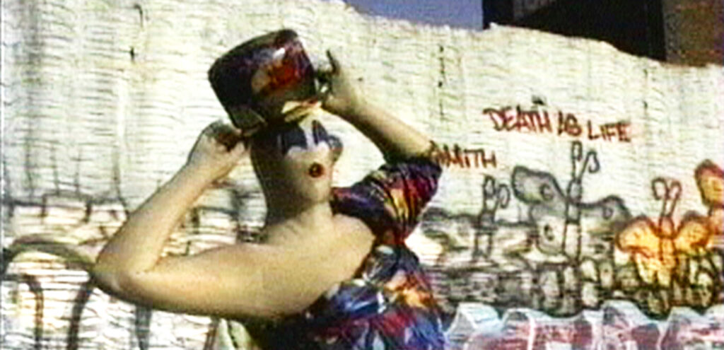A still from a film by Charles Atlas that features a man dressed as "Mrs. Peanut"