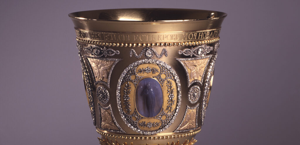 A close-up detail of an elaborately ornamented gold chalice that once belonged to Catherine the Great