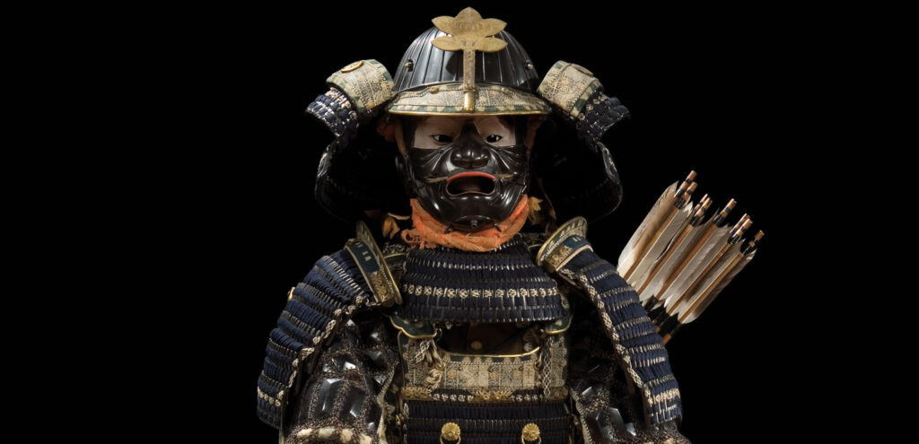 A dramatically lit piece of samurai armor, emerging from a dark background
