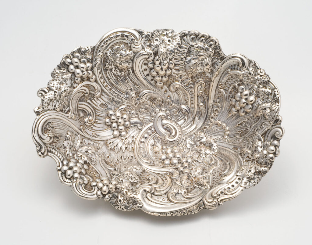 An elaborately decorated silver berry bowl from the late 19th century