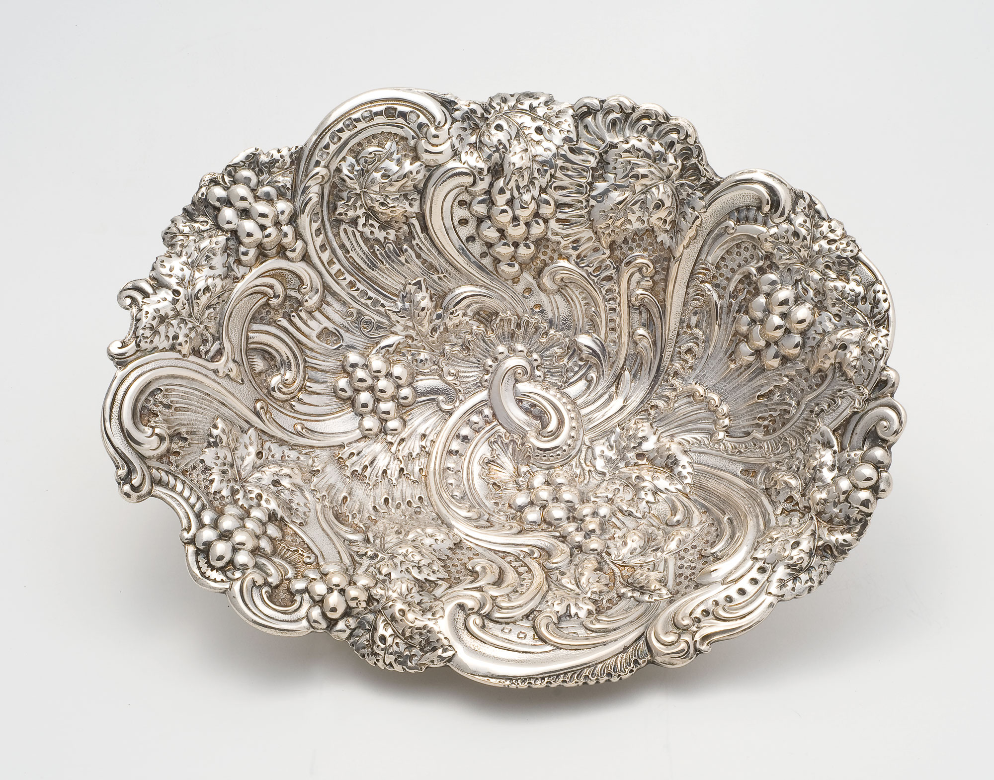 An elaborately decorated silver berry bowl from the late 19th century