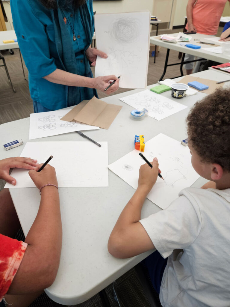 Children learn how to sketch in a Just My Imagination workshop
