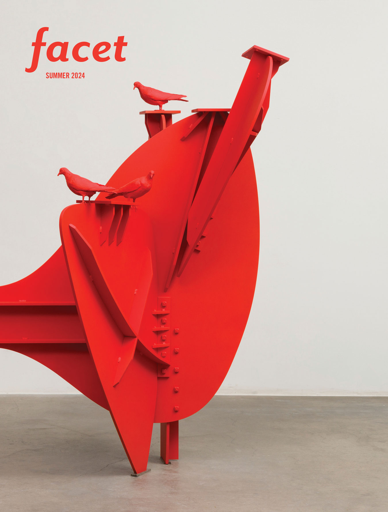 Red sculpture with small birds perched on top