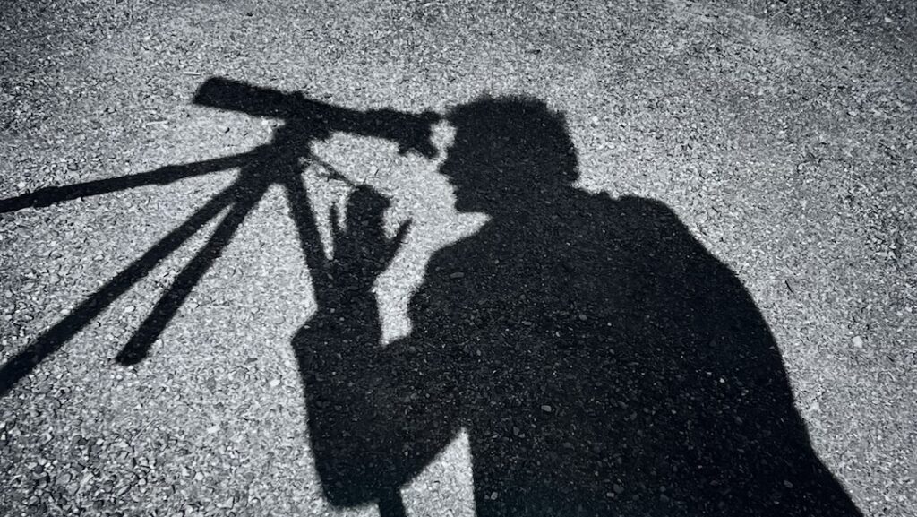Arthur Tress' photograph depicts the shadow of a man looking into a telescope