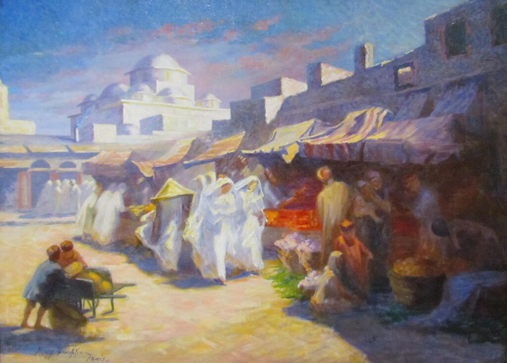 A group of women wearing all white pass by vendors at an outdoor market with a mosque visible in the background