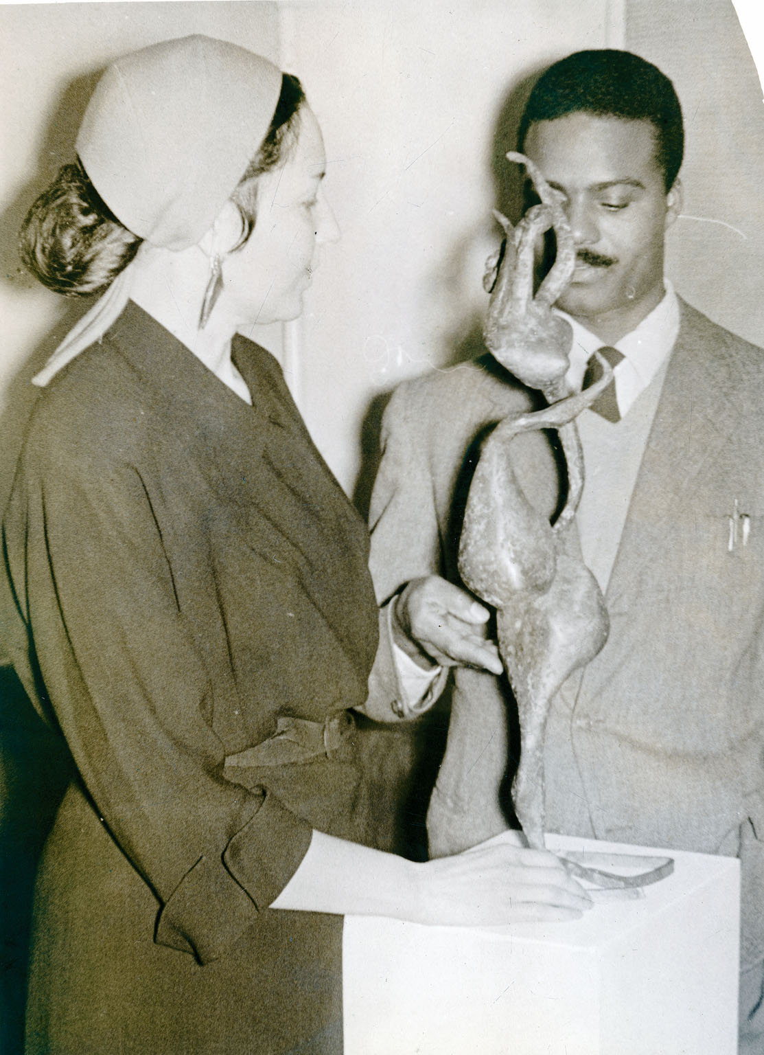 Undated black and white photograph of John and Richenda Roden posing with one of John Rhoden's sculptures at an exhibition.