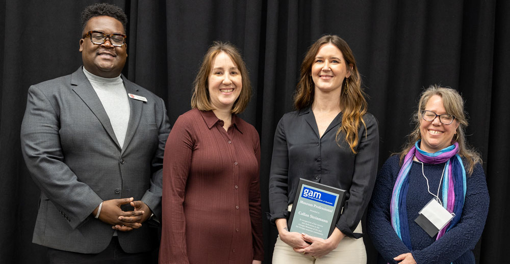 Callan Steinmann, the museum's director of learning and engagement, receives her award for museum professional of the year at the 2026 Georgia Association of Museums conference.