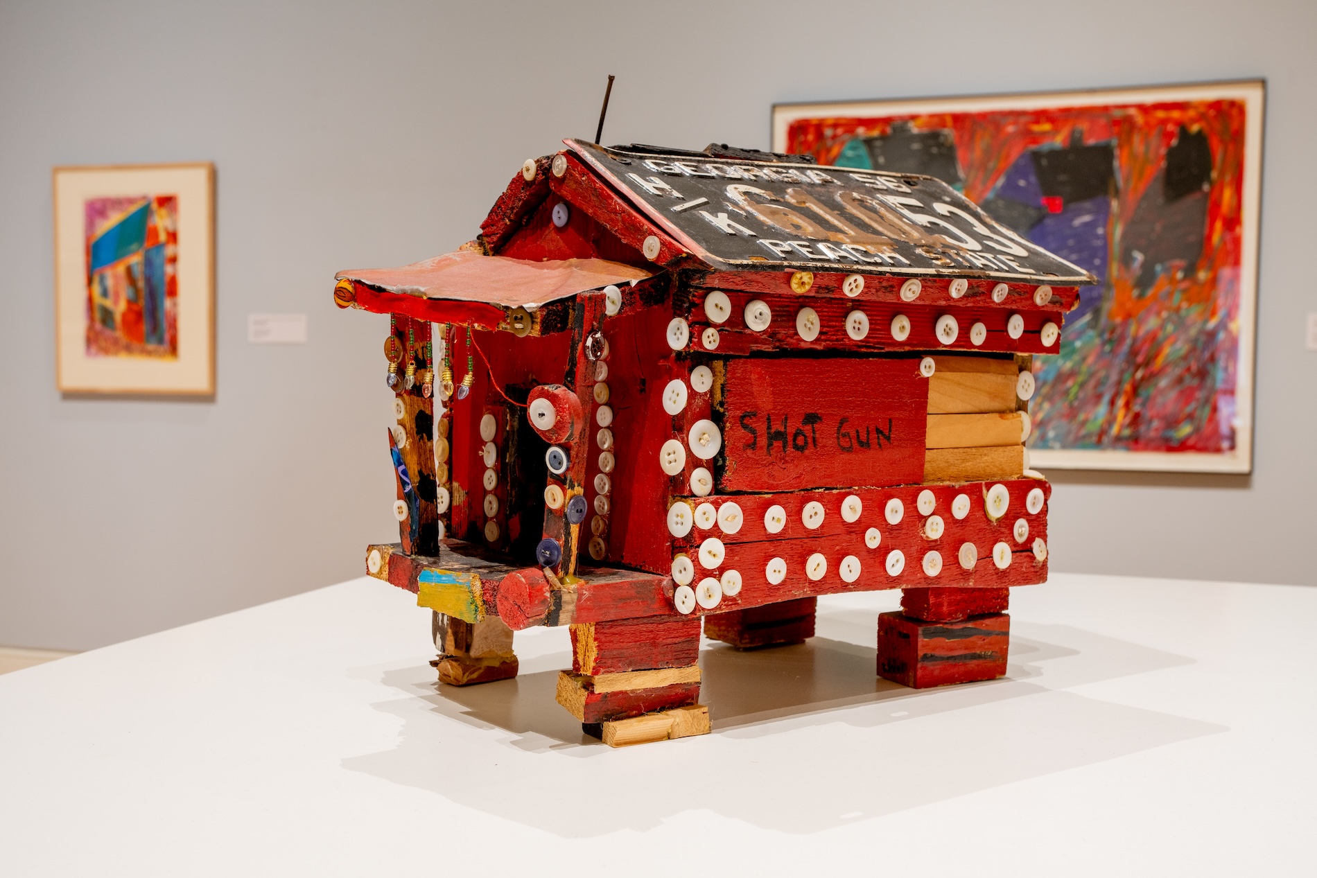Beverly Buchanan's three-dimensional model of a shotgun house is made from scrap wood and decorated with buttons and a license plate