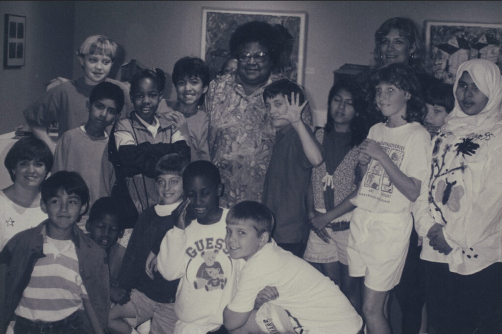 Black and white photograph of Beverly Buchanan and a school group.